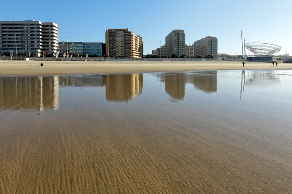 City of Matosinhos reflected on the wet sand Stock Picture