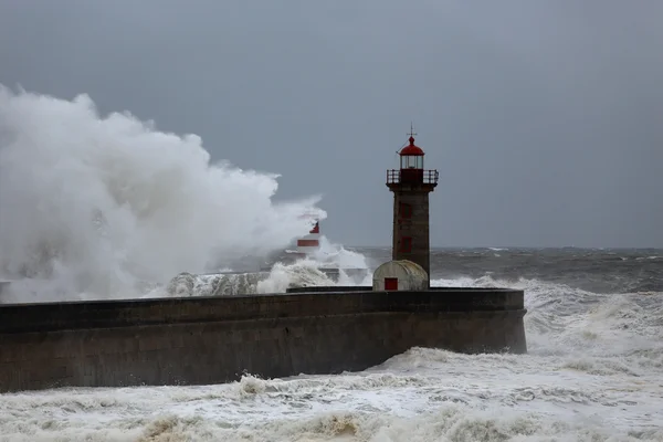 Stormy wave over lighthouses and piers