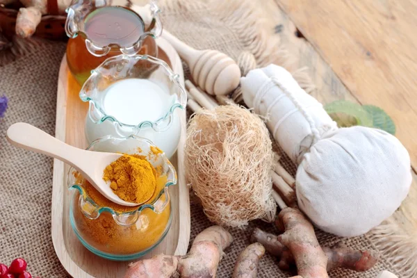 Turmeric powder with honey and milk for scrub. — Stock Photo, Image