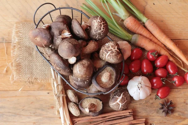 Mushrooms and vegetables on wood background. — Stock Photo, Image