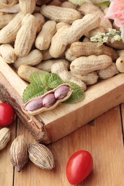 Peanut and boiled peanuts on wood background. — Stock Photo, Image