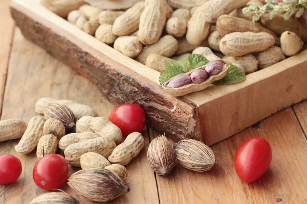 Peanut and boiled peanuts on wood background. — Stock Photo, Image