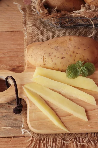 Färsk potatis för matlagning på trä bakgrund — Stockfoto