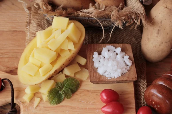 Fresh potatoes for cooking on wood background — Stock Photo, Image