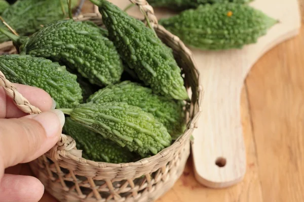 Bitter melon and sliced on wood background — Stock Photo, Image