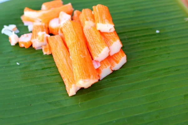 Crab sticks on a banana leaf — Stock Photo, Image