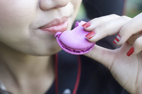 Frau isst köstlich französische Makronen — Stockfoto