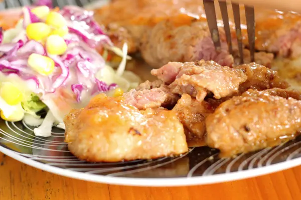 Steaks, french fries with vegetables salad on a plate. — Stock Photo, Image