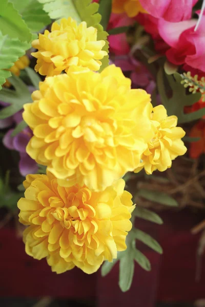 Beautiful vintage of artificial yellow flowers — Stock Photo, Image