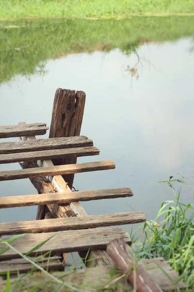 Old wooden bridge on the lake — Stock Photo, Image