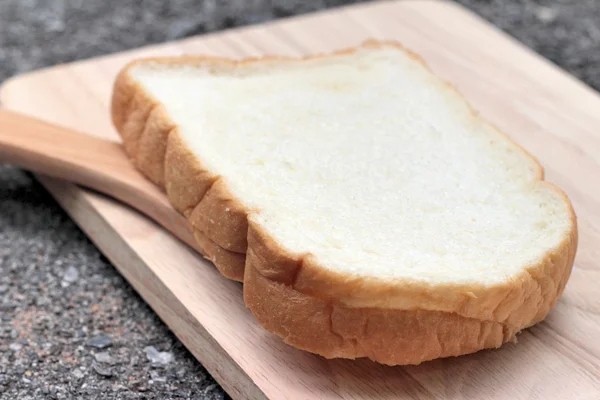 Slice of bread on wood background — Stock Photo, Image