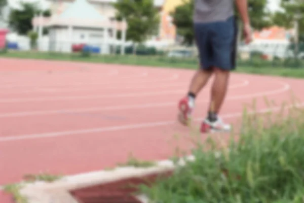 Blurred man running track for in the stadium. — Stock Photo, Image