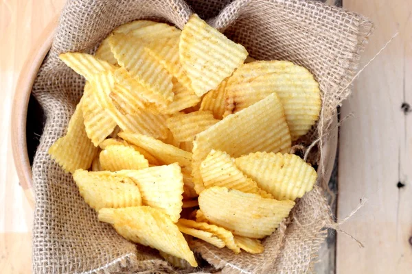 Potato chip on wood background — Stock Photo, Image