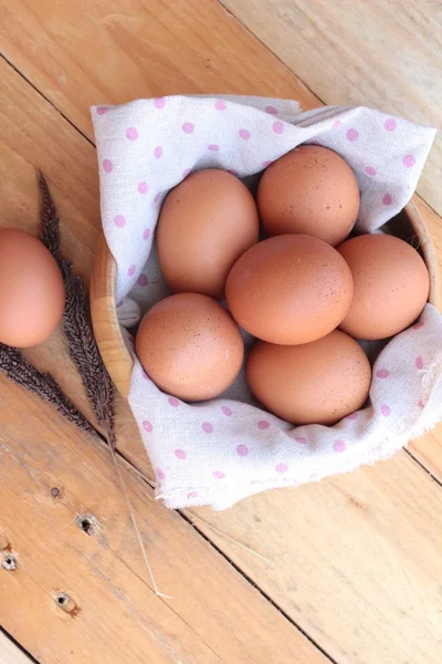 Chicken brown eggs on wood background