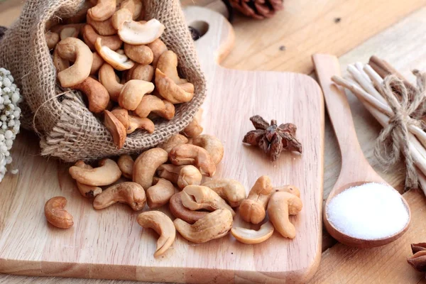 Anacardi arrosto noci con naturale su sfondo di legno — Foto Stock