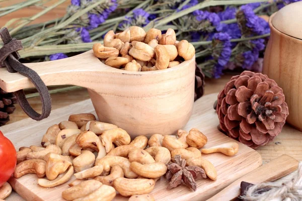 Roasted cashews nuts with natural on wood background — Stock Photo, Image