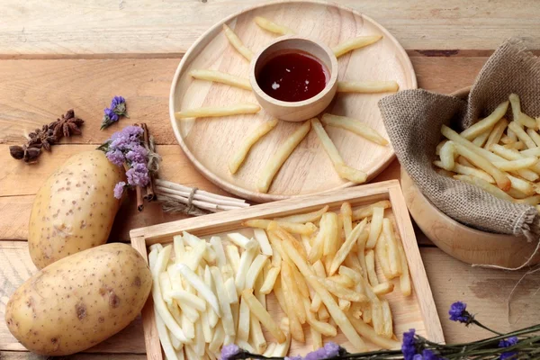 French fries and fresh sliced potatoes with ketchup. — Stock Photo, Image