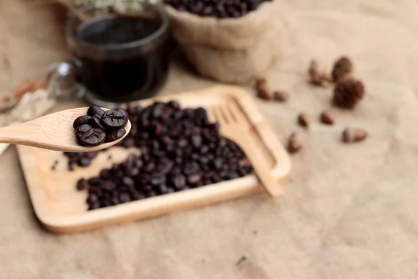 Roasted coffee beans with hot coffee — Stock Photo, Image