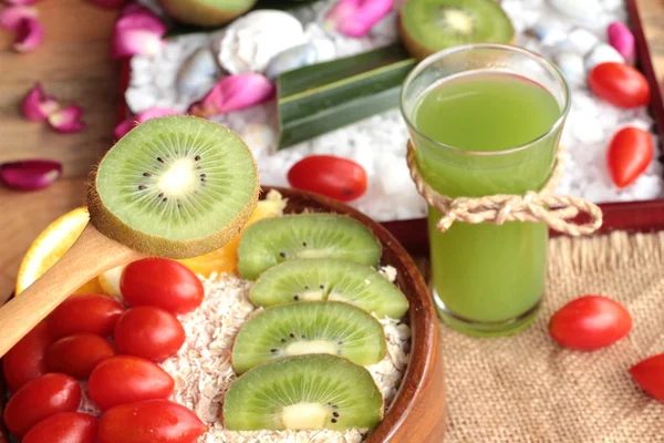 Fiocchi d'avena con succo di frutta, kiwi, arancia, pomodoro e kiwi . — Foto Stock