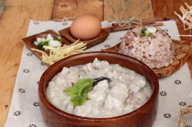 Brown rice porridge put pork and brown rice with soft-boiled egg clipart