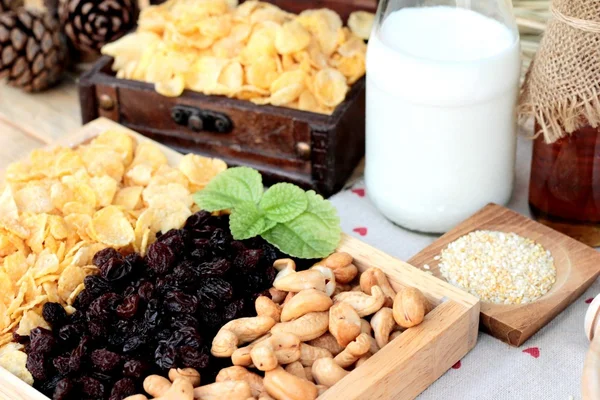 Corn flake with currant dried fruit ,cashew nuts and milk. — Stock Photo, Image