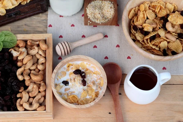 Corn flake with currant dried fruit ,cashew nuts and milk.