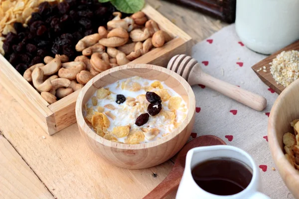 Corn flake with currant dried fruit ,cashew nuts and milk. — Stock Photo, Image