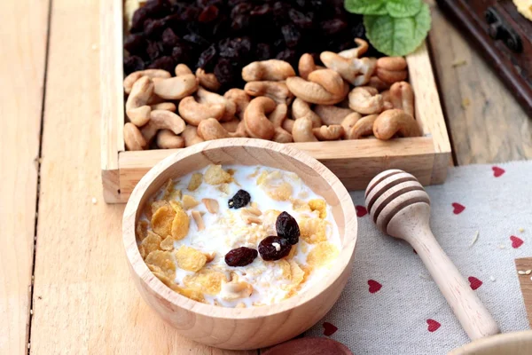 Corn flake with currant dried fruit ,cashew nuts and milk.