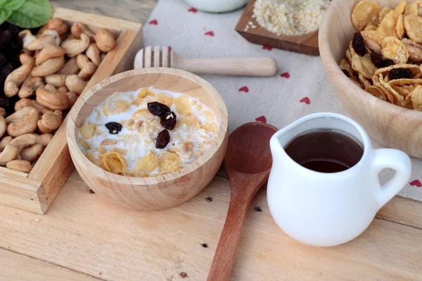 Corn flake with currant dried fruit ,cashew nuts and milk. — Stock Photo, Image