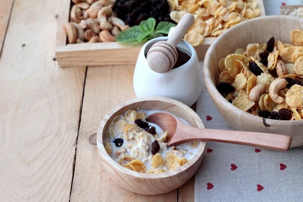 Corn flake with currant dried fruit ,cashew nuts and milk. — Stock Photo, Image