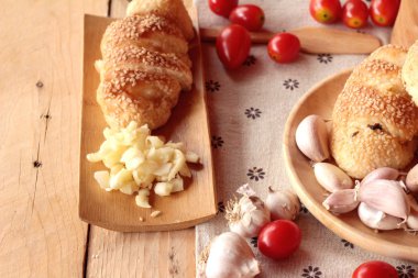 Sarımsaklı ekmek ot ahşap arka plan üzerinde lezzetli.