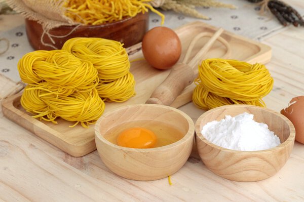 Making yellow noodle with egg and wheat flour.