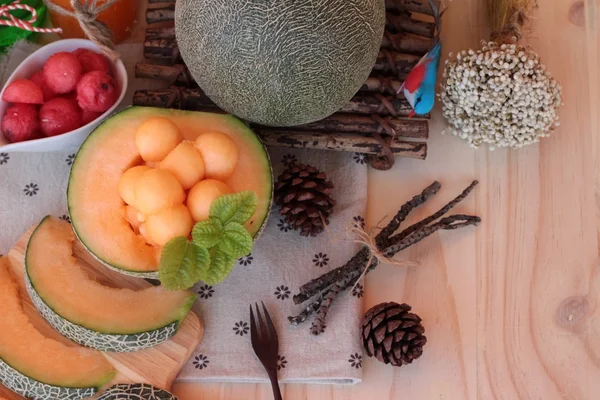 Orange cantaloupe melon fruit juicy on wood background. — Stock Photo, Image