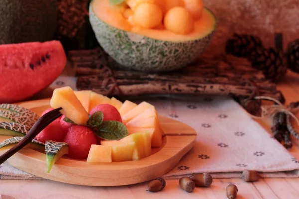 Orange cantaloupe melon fruit juicy on wood background. — Stok Foto