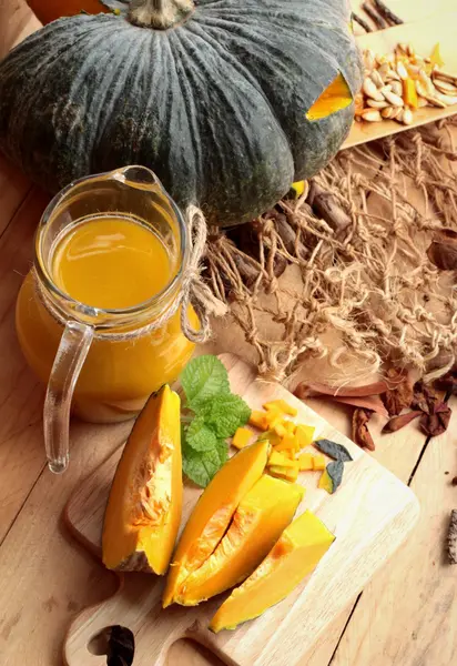 Halloween pumpkins and pumpkin soup on wood background. — Stock Photo, Image