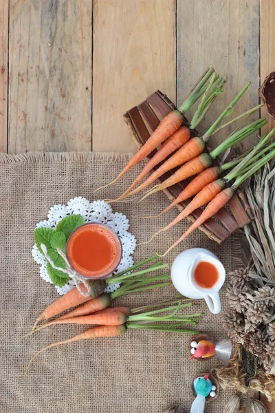 Succo di carota spremuto fresco e carote fresche . — Foto Stock