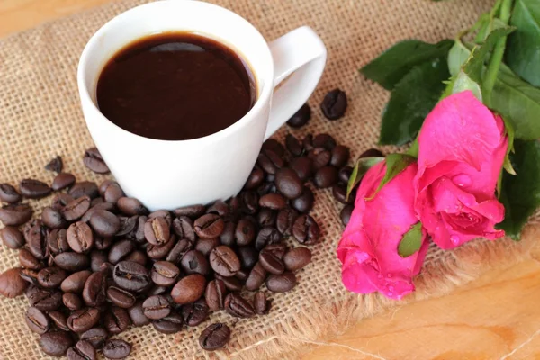 Coffee with coffee beans and roses.