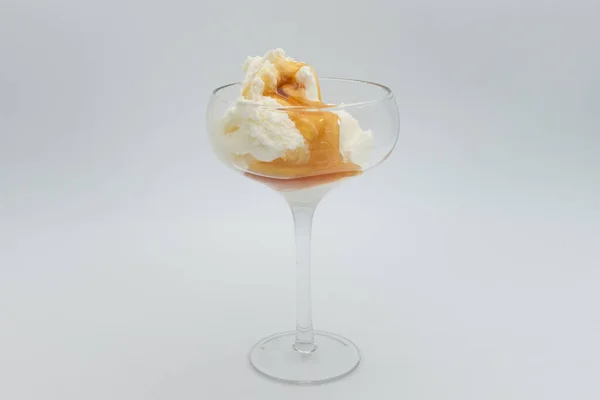 Vanilla ice cream with calamel syrup in glass on white background. — Stock Photo, Image