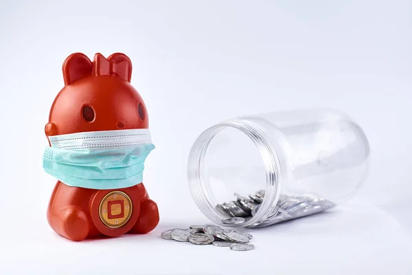 Red Piggy bank wear medical mask on white. health photo concept