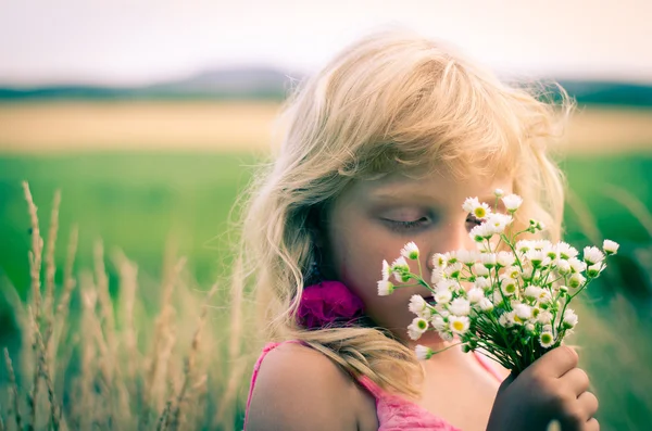 Kid with bunch of flowers — Stock Photo, Image