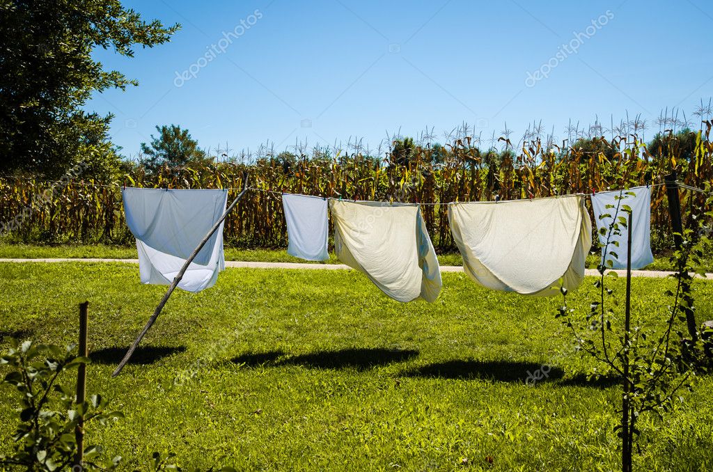 Wet clothes drying in the rope line Stock Photo by ©KatarinaGondova  112329570