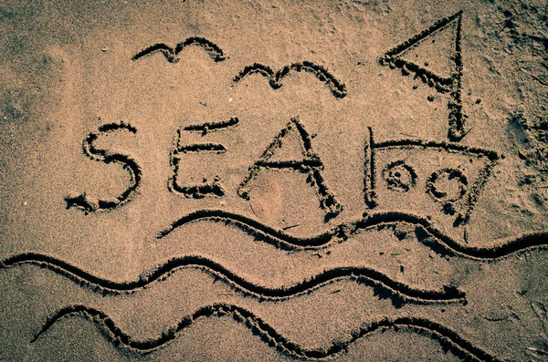 Parole di mare disegnate nella sabbia — Foto Stock