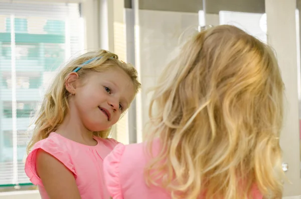 Blond girl in mirror — Stock Photo, Image