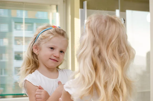 Blond girl in mirror — Stock Photo, Image