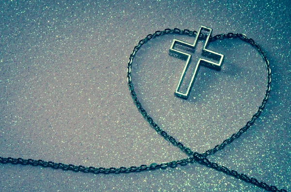 Kruis symbool in keten liefde vorm — Stockfoto