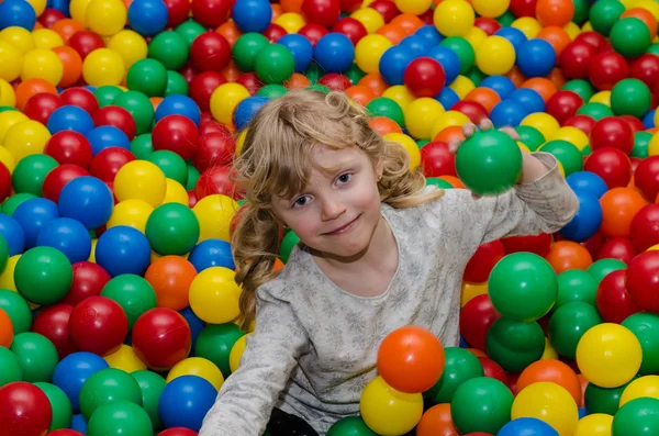 Happy girl playing with balls — Stock Photo, Image