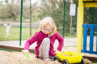 kum ile sahada oynayan çocuk