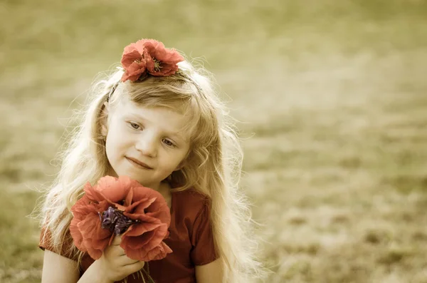 Girl with red flowers — Stock Photo, Image
