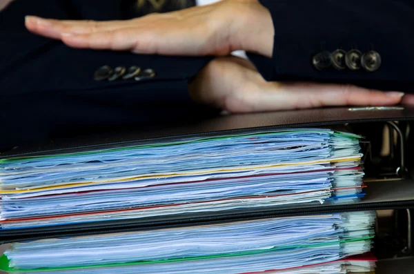 hands on pile of folders