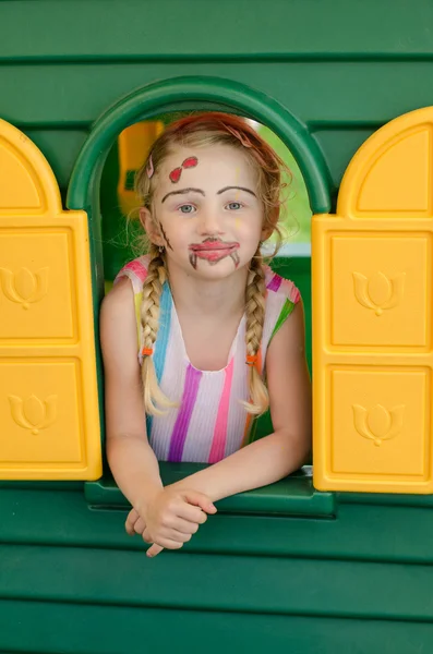 Girl with facepainting in colorful house — Stock Photo, Image